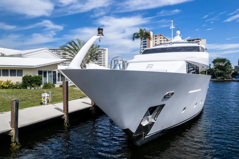 Slide: The Image of Luxury 1998 Intermarine 118 yacht docked by waterfront buildings. - 9