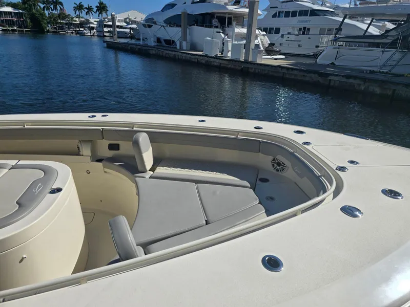 Slide: The Image of 2024 Scout 355 LXF boat interior with seating, docked at marina. - 14