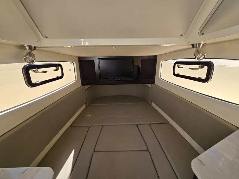 Slide: The Image of 2024 Scout 355 LXF cabin interior with windows and a TV. - 29