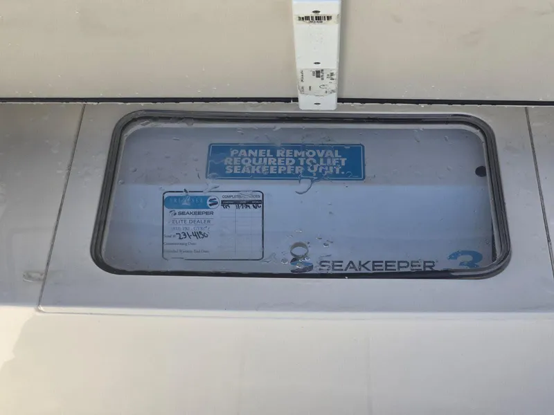 Slide: The Image of 2024 Scout 355 LXF Seakeeper panel with removal instructions. - 33