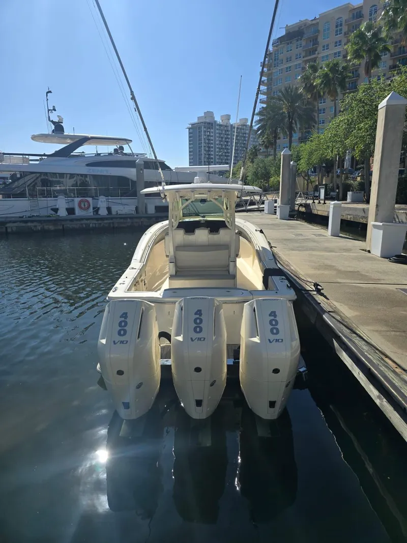 Slide: The Image of 2024 Scout 355 LXF boat docked with triple 400 V8 engines. - 4