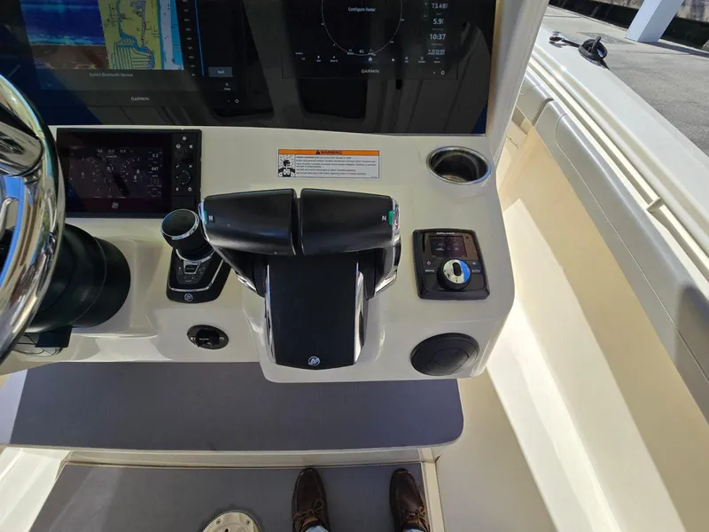 Slide: The Image of 2024 Scout 355 LXF boat dashboard with navigation controls and display screens. - 7