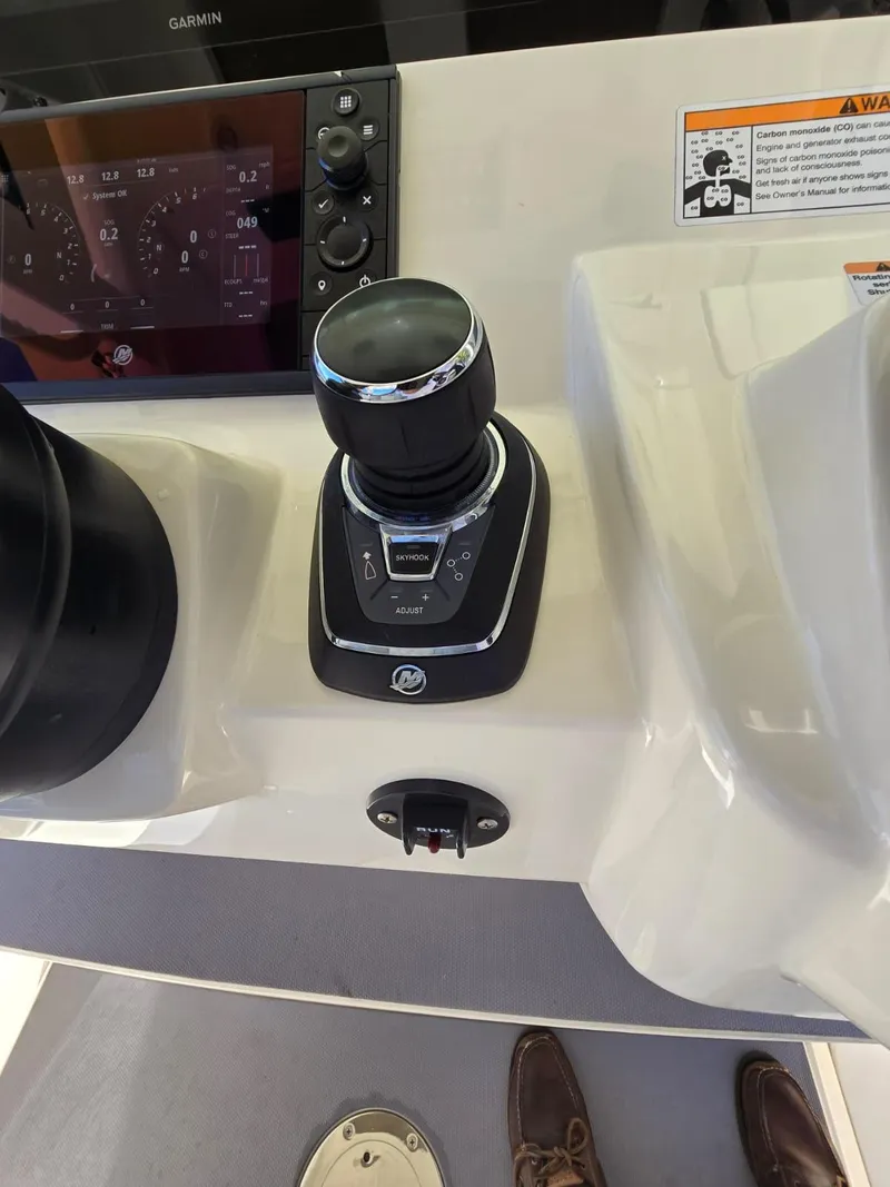 Slide: The Image of 2024 Scout 355 LXF boat control panel with joystick and display screen. - 8