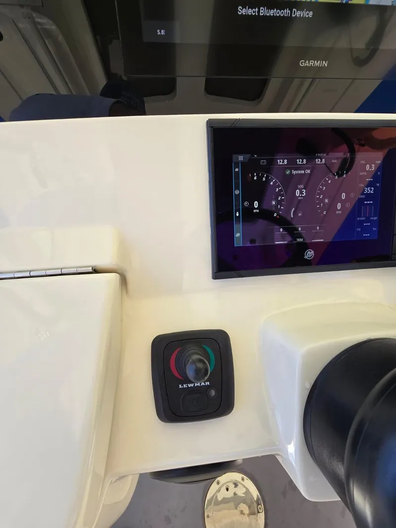 Slide: The Image of 2024 Scout 355 LXF boat dashboard with Garmin display and controls. - 9