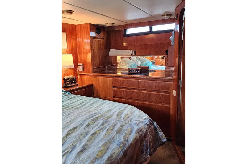 Slide: The Image of Luxurious interior of 2000 Novatec Cockpit Motor Yacht with wood paneling and cozy bedding. - 12