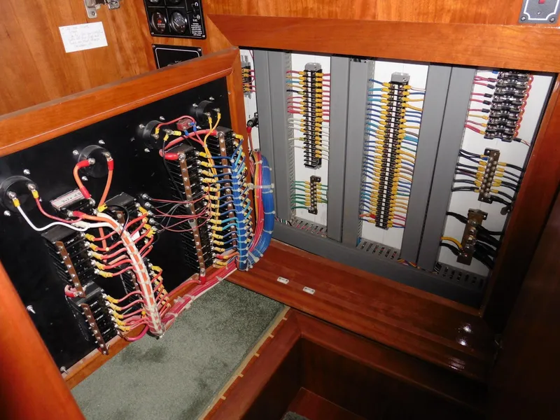 Slide: The Image of Electrical panel inside 2000 Novatec Cockpit Motor Yacht, showcasing wiring and circuit components. - 20