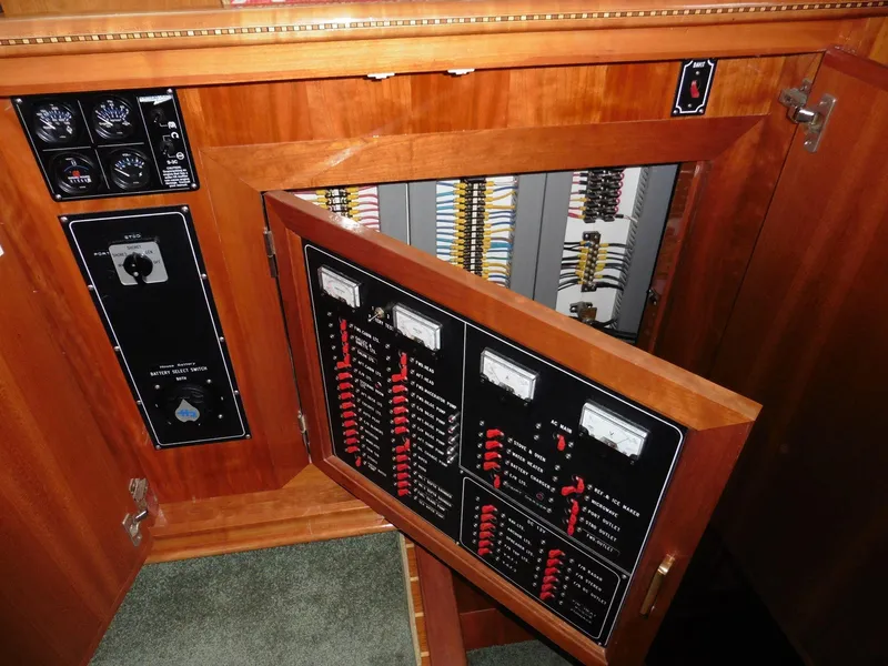 Slide: The Image of Electrical panel inside a 2000 Novatec Cockpit Motor Yacht, showcasing wiring and controls. - 21