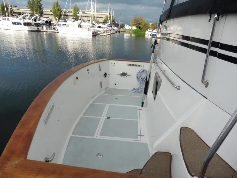 Slide: The Image of Novatec Cockpit Motor Yacht 2000, spacious deck, docked in marina with other boats. - 24