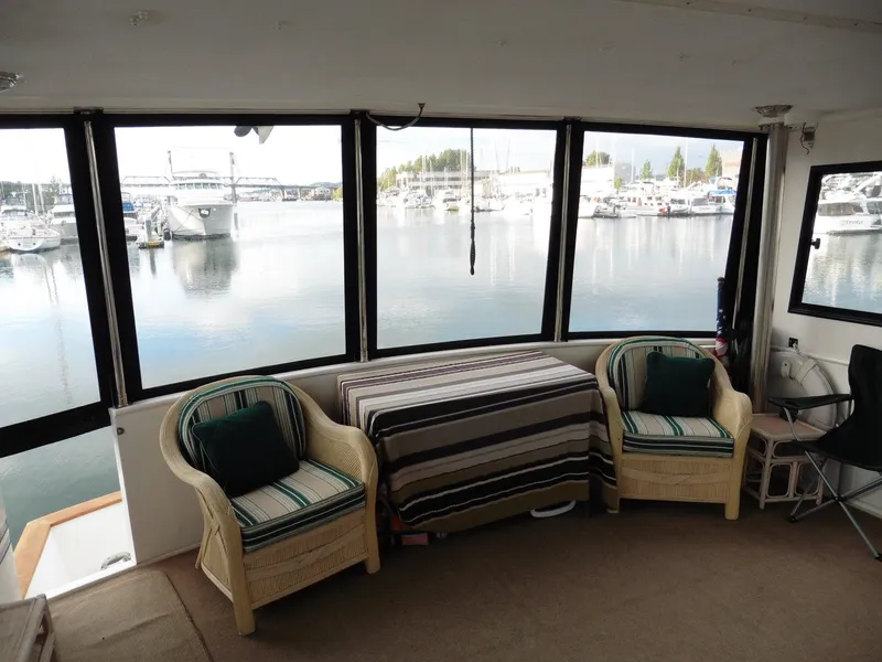 Slide: The Image of Novatec Cockpit Motor Yacht 2000 interior with wicker chairs and marina view. - 28