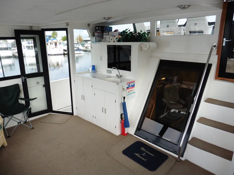 Slide: The Image of Interior of 2000 Novatec Cockpit Motor Yacht with kitchenette and seating area. - 29