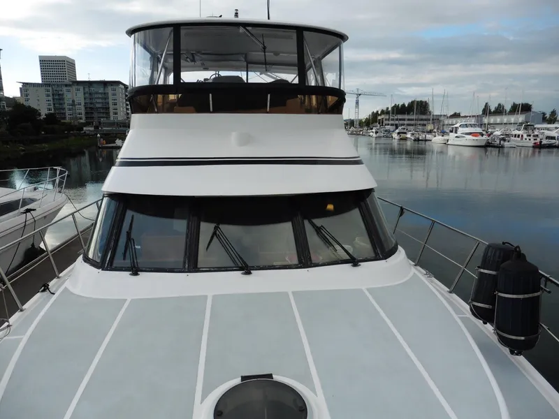 Slide: The Image of Novatec Cockpit Motor Yacht 2000 docked in marina, showcasing sleek design and spacious deck. - 31