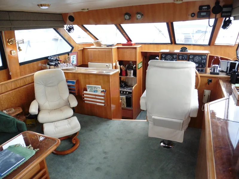 Slide: The Image of Interior of 2000 Novatec Cockpit Motor Yacht with helm, seating, and kitchenette. - 4