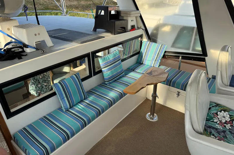 Slide: The Image of Interior of 2000 Novatec Cockpit Motor Yacht with striped seating and wooden table. - 46