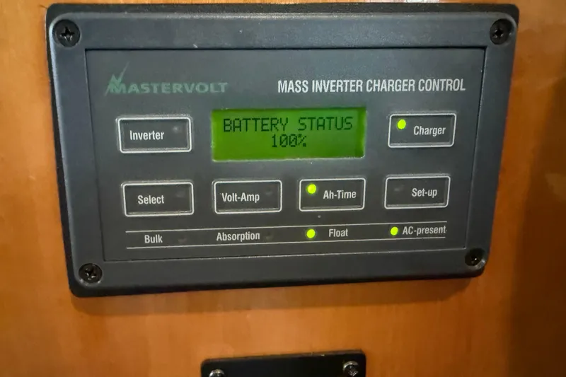 Slide: The Image of Mastervolt inverter charger control panel on 2000 Novatec Cockpit Motor Yacht, showing 100% battery status. - 53