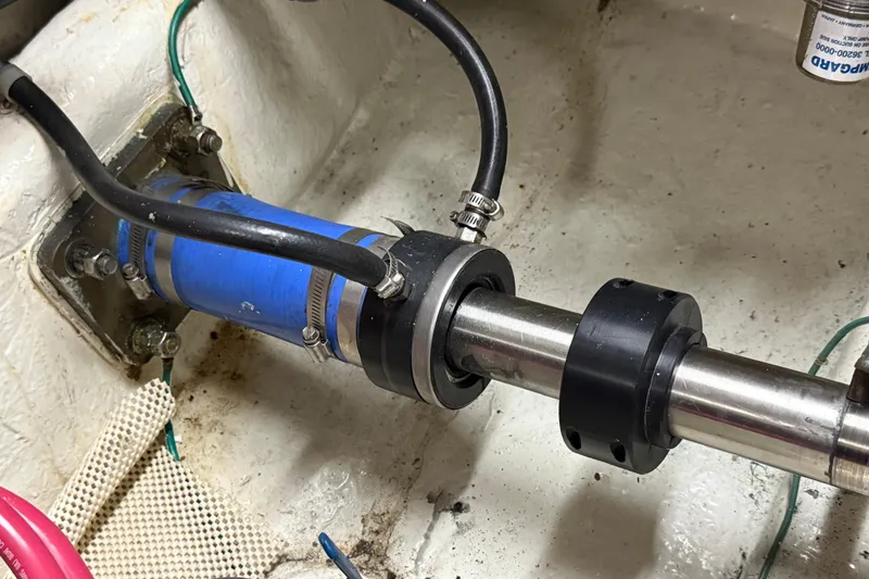 Slide: The Image of Novatec Cockpit Motor Yacht 2000 engine shaft with blue hose and metal clamps. - 55