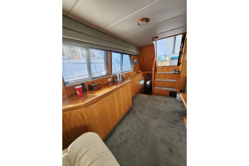 Slide: The Image of Interior of 2000 Novatec Cockpit Motor Yacht with wooden cabinetry and carpeted flooring. - 61