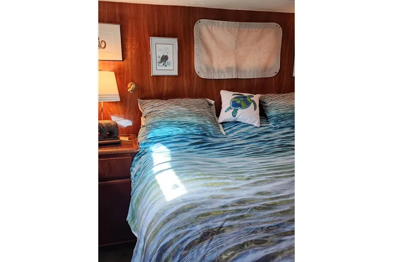 Slide: The Image of Cozy bedroom in 2000 Novatec Cockpit Motor Yacht with ocean-themed bedding and turtle pillow. - 63