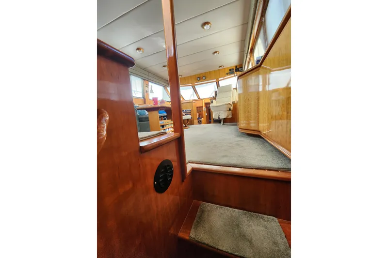 Slide: The Image of Interior view of 2000 Novatec Cockpit Motor Yacht with wooden finishes and carpeted flooring. - 65