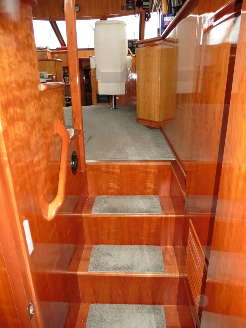 Slide: The Image of Interior of 2000 Novatec Cockpit Motor Yacht with polished wood and carpeted steps. - 7