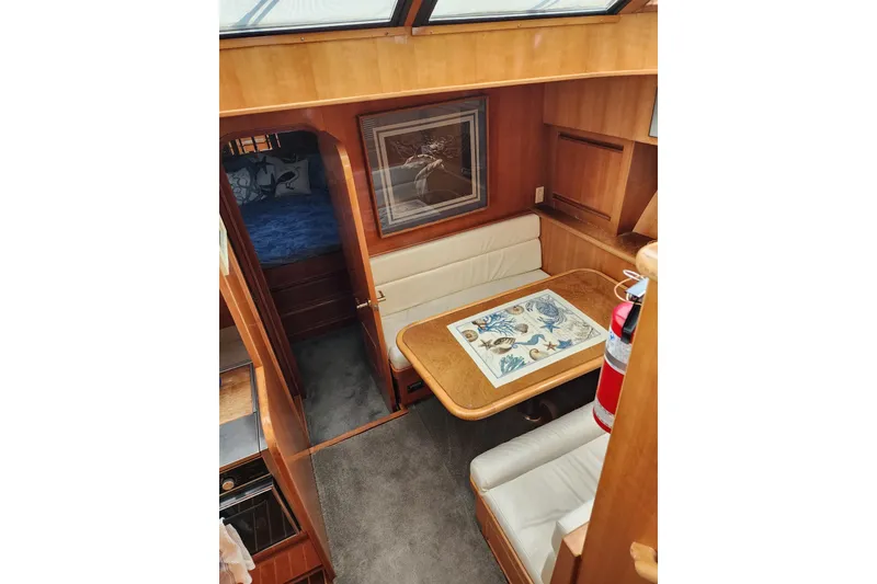 Slide: The Image of Interior of 2000 Novatec Cockpit Motor Yacht with dining area and cozy seating. - 9