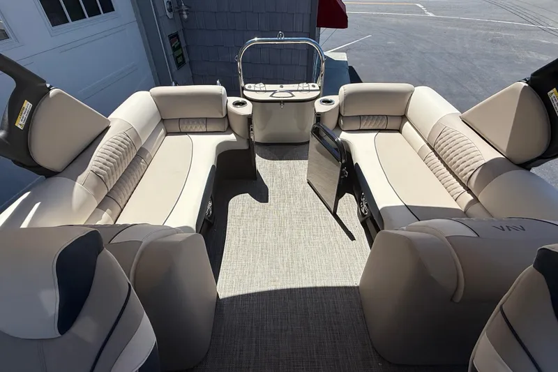 Slide: The Image of 2026 Avalon 2385 Catalina Quad Lounger interior with beige seating and cup holders. - 22