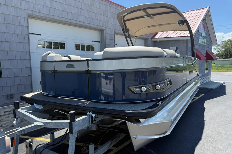Slide: The Image of 2026 Avalon 2385 Catalina Quad Lounger, Tri Toon High Performance boat in a parking lot. - 4