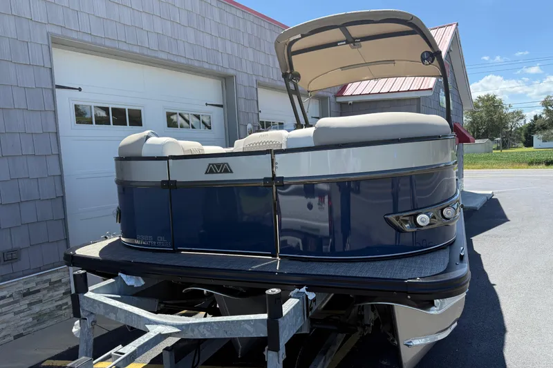 Slide: The Image of 2026 Avalon 2385 Catalina Quad Lounger Tri Toon boat, parked outdoors, showcasing sleek design. - 5