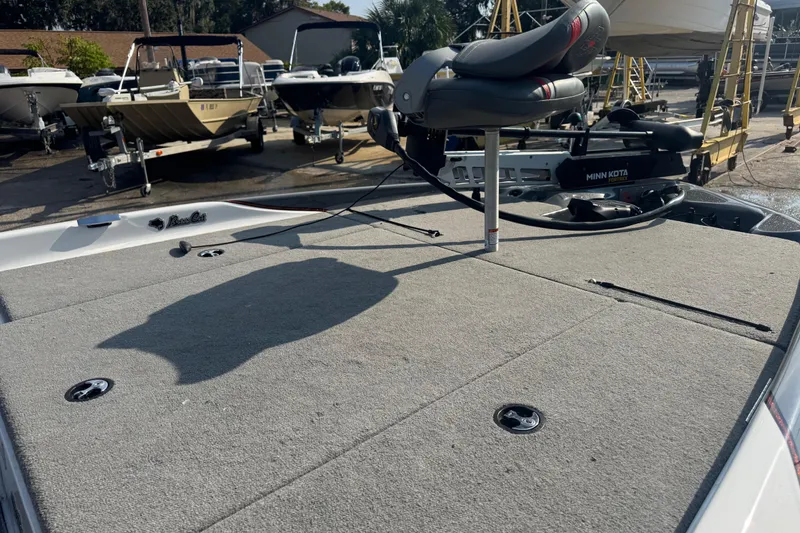 Slide: The Image of 2021 Bass Cat Margay boat deck with Minn Kota trolling motor in a marina. - 21