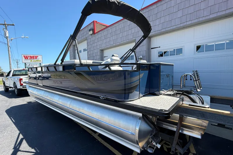 Slide: The Image of 2025 Avalon 2385 Venture 85 Tri Toon boat, high performance, parked outside dealership. - 7