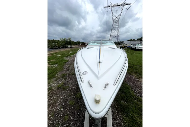 Slide: The Image of 1999 Formula 271 FASTech boat on trailer, under cloudy sky near power lines. - 13