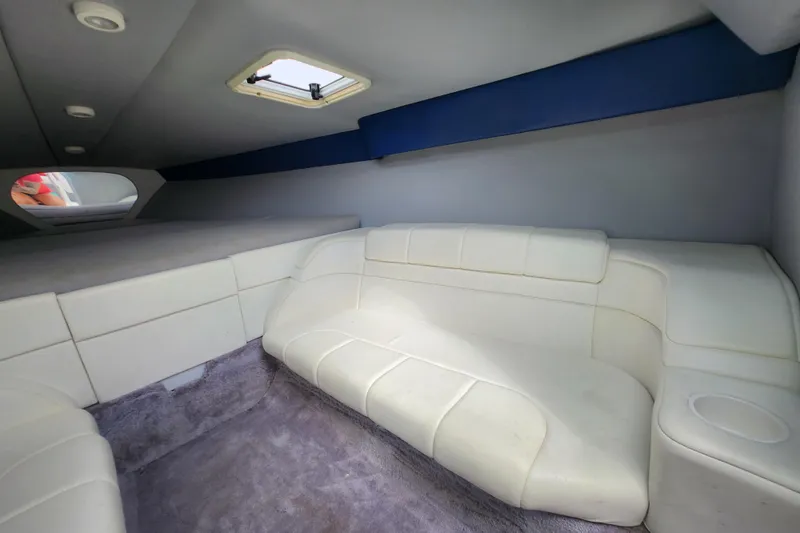 Slide: The Image of Interior of 1999 Formula 271 FASTech boat with white seating and carpeted floor. - 15