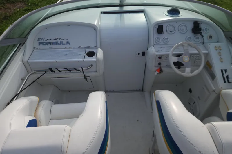 Slide: The Image of 1999 Formula 271 FASTech boat cockpit with white seating and control panel. - 17