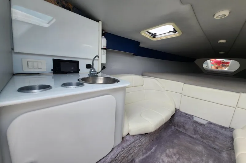 Slide: The Image of Interior of 1999 Formula 271 FASTech boat with kitchenette and seating area. - 18