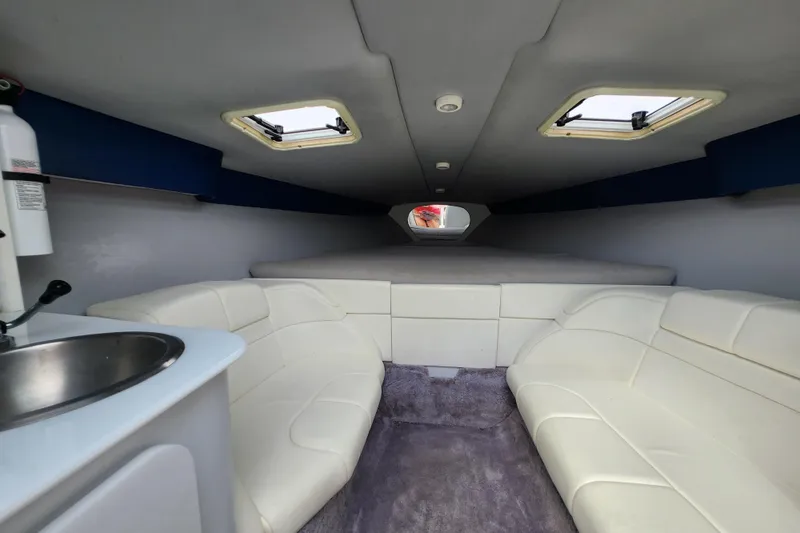 Slide: The Image of Interior of 1999 Formula 271 FASTech boat with white seating and small sink. - 19