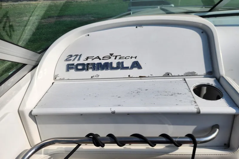 Slide: The Image of 1999 Formula 271 FASTech boat dashboard with logo and cup holder. - 20