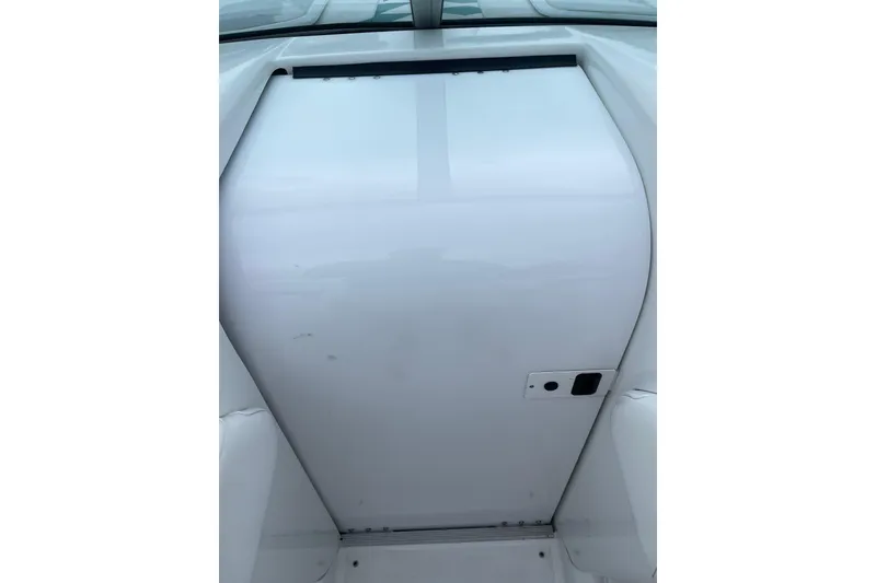 Slide: The Image of 1999 Formula 271 FASTech boat hatch, white surface with handle and latch. - 21