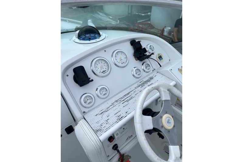 Slide: The Image of Dashboard of a 1999 Formula 271 FASTech boat with gauges and steering wheel. - 22