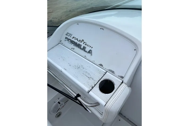 Slide: The Image of 1999 Formula 271 FASTech boat dashboard with cup holder and logo. - 29
