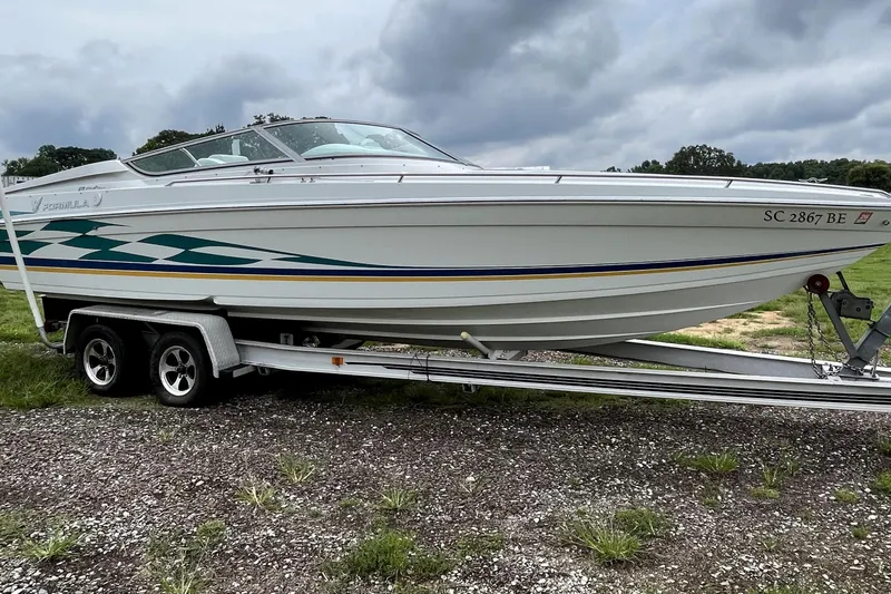 Slide: The Image of 1999 Formula 271 FASTech boat on trailer, parked outdoors under cloudy sky. - 3