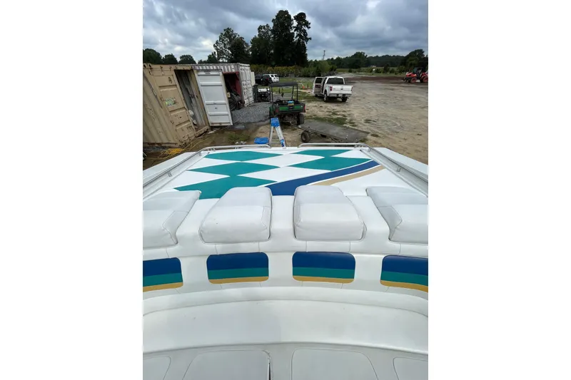 Slide: The Image of 1999 Formula 271 FASTech boat with colorful deck design, parked outdoors. - 30