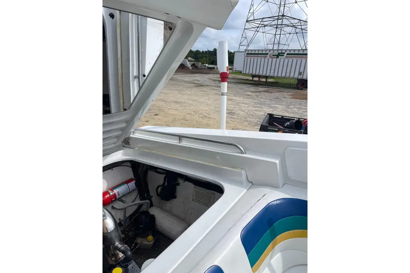 Slide: The Image of 1999 Formula 271 FASTech boat engine compartment, open hatch, outdoor setting. - 34