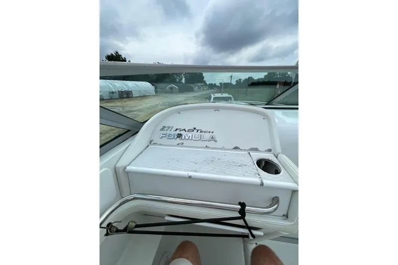 Slide: The Image of 1999 Formula 271 FASTech boat interior with overcast sky in the background. - 38