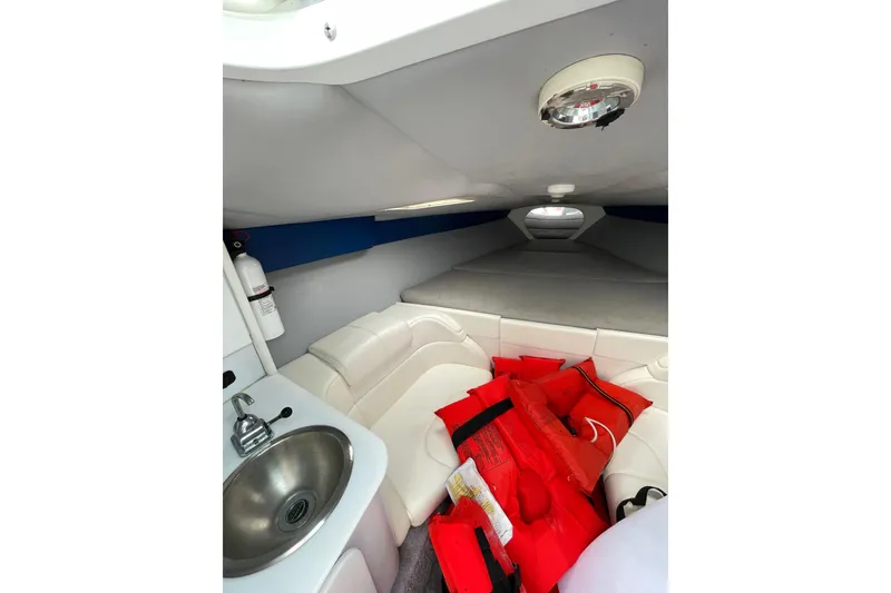 Slide: The Image of Interior of 1999 Formula 271 FASTech boat with sink, seating, and life jackets. - 42