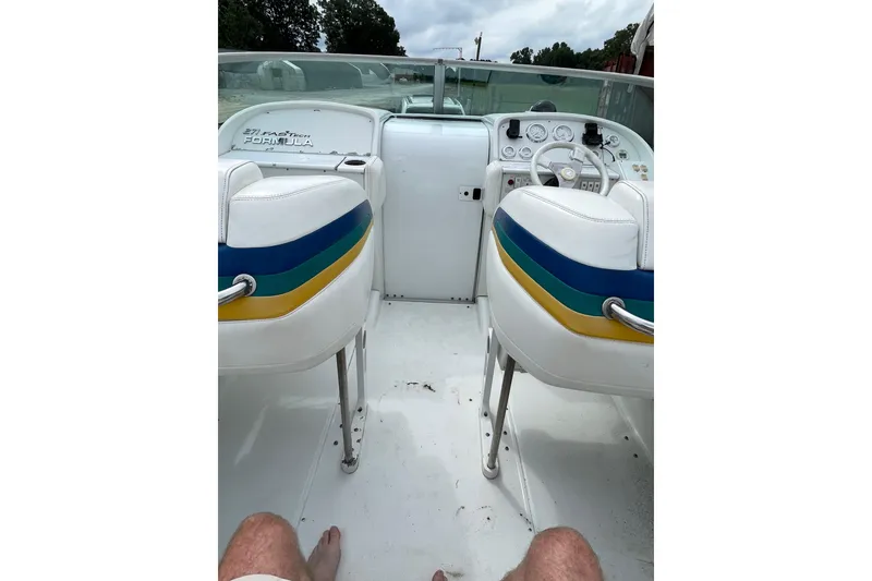 Slide: The Image of 1999 Formula 271 FASTech boat interior with colorful seats and dashboard view. - 43