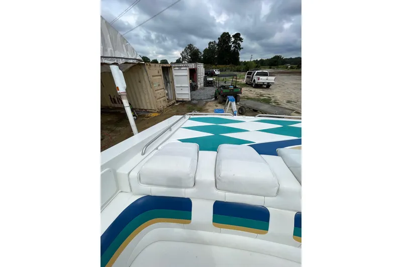 Slide: The Image of 1999 Formula 271 FASTech boat with colorful upholstery, parked outdoors under cloudy skies. - 44