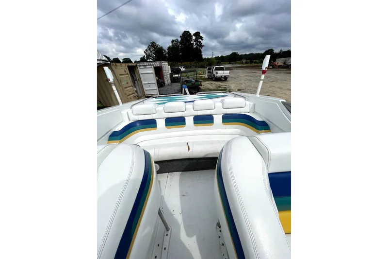 Slide: The Image of 1999 Formula 271 FASTech boat interior with colorful seating under cloudy sky. - 47