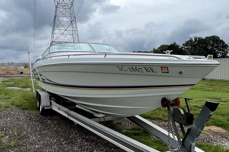 Slide: The Image of 1999 Formula 271 FASTech boat on trailer, parked outdoors under cloudy sky. - 7