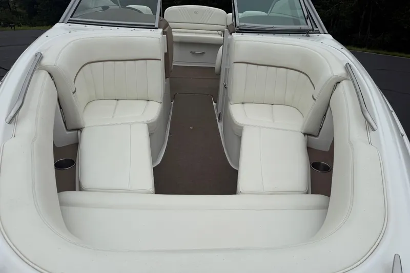 Slide: The Image of 2007 Cobalt 232 boat interior with white leather seating and cup holders. - 10