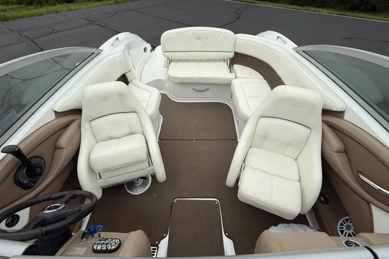 Slide: The Image of 2007 Cobalt 232 boat interior with white leather seats and brown accents. - 11