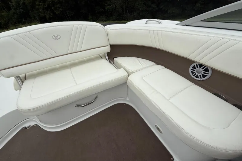 Slide: The Image of 2007 Cobalt 232 boat interior with white leather seating and speaker detail. - 14